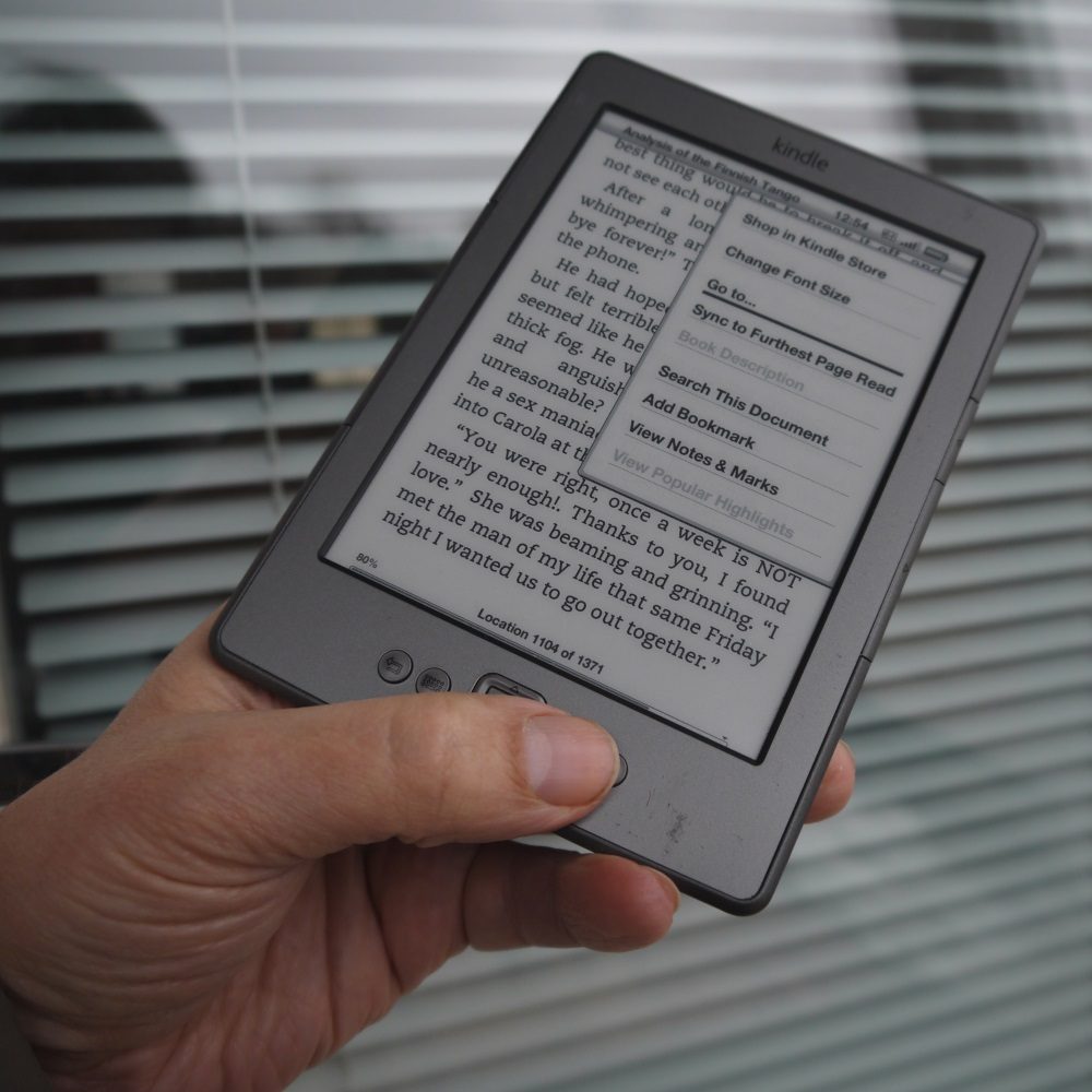 Amazon Kindle e-reader in hand