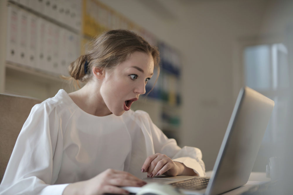 astonished woman looking at laptop computer