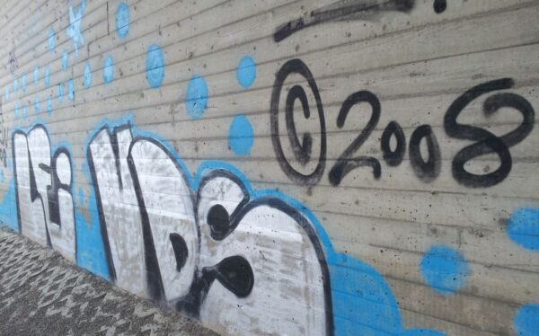 graffity under a bridge with copyright